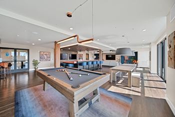 Game room with poker table, video gaming connections and ping pong